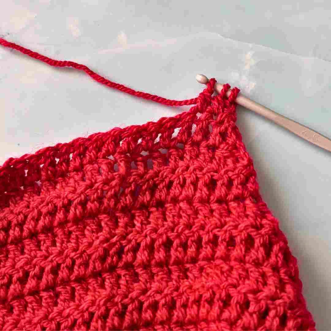 Simple Horse ear bonnet crochet pattern (6) explaining how to work dc2tog crochet stitch